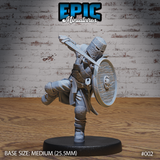 Armoured knight mid-charge, one knee raised, sword arm swept back overhead, round shield raised with carved emblem, wearing a riveted great helm and mail hauberk with belted surcoat. Sculpt by Epic Miniatures.