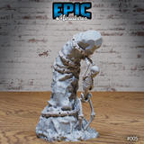 Skeleton miniature bent forward over a tall chained rock pillar, ribcage and arm bones clearly detailed, with chain links coiling from base to crown. Sculpt by Epic Miniatures.