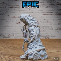 Skeleton figure leaning against a heavily chained rocky column, viewed from the side, showing the full wrap of chain links and the organic texture of the stone. Sculpt by Epic Miniatures.