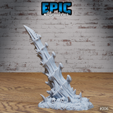 A single bone spike terrain piece viewed from a slightly lower angle, showing the full height of the twisted fused bone columns and the cluster of shard growths at the base, with skulls embedded in the rubble. Sculpt by Epic Miniatures.