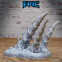Two assembled bone spike terrain pieces on a shared rubble base displayed from a slightly elevated angle, showing both pieces together and the full extent of the skull and bone debris surrounding them. Sculpt by Epic Miniatures.