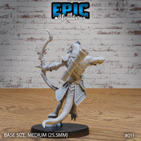 Lizardfolk archer viewed from behind, showing scaled hide, wrapped quiver pack across the back, armoured shoulders, and a sweeping tail curving down to a rocky base. Sculpt by Epic Miniatures.