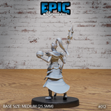 Female dark elf sorceress miniature seen from behind, spear raised, showing detailed backplate armour, layered pauldrons, and a wide flowing tabard. Hair trails in a high ponytail. Sculpt by Epic Miniatures.