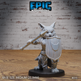 Stocky cat-folk warrior thrusting a long spear forward with right hand, large kite shield raised in left hand bearing a cat-head heraldic device, snarling muzzle, tufted ears pricked forward, wearing layered fur and leather armour. Sculpt by Epic Miniatures.