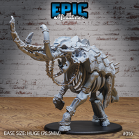 Skeletal elephant miniature in a charging pose, tusks wrapped in barbed chains, exposed ribcage, cracked skull, spiked armour plates across back and shoulders, huge 76.5mm base. By Epic Miniatures.