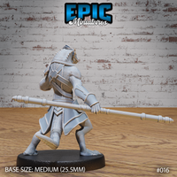 Lizardfolk monk viewed from behind, showing broad scaled shoulders, cross-body armour straps, layered back plating, and a low spear held horizontally at hip height. Dense scale texture visible across legs and tail. Sculpt by Epic Miniatures.