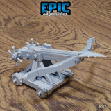 Siege ballista war machine on a four-wheeled rolling platform, bolt loaded and torsion arm horizontal, with twin multi-spoke winch handles at the rear. Sculpt by Epic Miniatures.