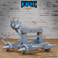 Dark Catapult war machine with arm raised and spiked iron basket aloft, showing the full wheeled chassis with spike-tipped axles and heavy timber frame. Sculpt by Epic Miniatures.