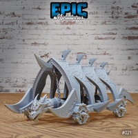 Dragon Head Battle Ram by Epic Miniatures — wheeled siege vehicle with a snarling draconic figurehead, swept dorsal fins, riveted armour plates, curved blades, and spiked wheels.