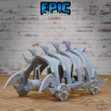 Dragon Head Battle Ram by Epic Miniatures — rear three-quarter view showing spiked wheels, hooked skid runners, scroll-worked axle caps, segmented armoured flanks, and chain detail along the chassis.