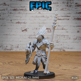 Lizardfolk warrior in layered plate armour standing upright, holding a long spear aloft in the right hand and a kite shield in the left, with a feathered crest helm and scaled hide. Sculpt by Epic Miniatures.