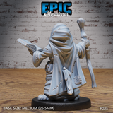 Canine humanoid wizard seen from behind, wearing a large stitched hood and heavily patched robe with a lattice-panel detail near the hem, staff raised in the right hand, open book held in the left. Sculpt by Epic Miniatures.