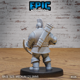Dwarven crossbowman viewed from behind, showing a large cylindrical bolt case strapped across his back with buckled leather harness. Scale mail covers the full torso, mohawk crest visible from above. Sculpt by Epic Miniatures.
