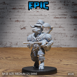 Stocky minotaur bard gripping a crossbow at chest height, wearing a buckled top hat and layered coat with a shamrock detail, crossbow slung forward; fiddle and bedroll visible across his back. Sculpt by Epic Miniatures.