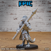 Armoured lizardfolk warrior holding a long spear over one shoulder, wearing plate armour with engraved trim over scaled hide, prominent dorsal crest, muscular tail extended behind. Sculpt by Epic Miniatures.