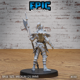 Dark elf halberdier viewed from behind, showing layered plate armour with interlocking segments, blade-like protrusions along the shoulders, and long flowing hair. Sculpt by Epic Miniatures.