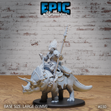 Armoured lizardfolk warrior riding a barded triceratops, holding a long barbed spear upright, wearing feathered-crested plate armour over scaled skin, mounted on a large 51mm round base. Sculpt by Epic Miniatures.