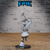 Orc warrior viewed from behind and side, hammer raised high, showing thick fur mantle across the shoulders, layered armour, skull-decorated belt, and bare gnarled feet. Sculpt by Epic Miniatures.