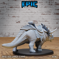 Armoured triceratops miniature viewed from the flank, showing layered leather saddle panels, braided girth straps, segmented tail armour, and richly textured hide across the body. Sculpt by Epic Miniatures.