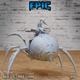 Giant spider mount seen from the rear, showing heavily textured abdomen and harness straps; dark elf rider visible from behind wearing angular plumed plate armour, crossbow extended to one side. Sculpt by Epic Miniatures.