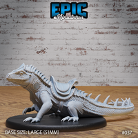 Giant saddled lizard miniature facing left, with overlapping scales, a full dorsal spine ridge, armoured barding flanks, a scrolled saddle, and a spiked tail. Sculpt by Epic Miniatures.