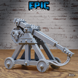 Siege catapult showing the full length of the throwing arm with spiked upper edge, heavy counterweight block, banded timber beams, and coiled rope sling hanging from the arm. Sculpt by Epic Miniatures.