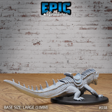 Large saddled reptile beast crouched low with dorsal spines and scaled tail extended behind it, clawed feet gripping the ground, saddle with ribbed detailing visible across the back. Sculpt by Epic Miniatures.