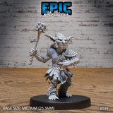 Snarling goblin warrior crouching forward, raising a heavy multi-headed mace overhead in one fist and clenching a spiked gauntlet in the other. Wearing a shoulder guard, rope bracers, and tattered kilt. Sculpt by Epic Miniatures.