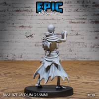 Skeleton miniature viewed from behind, tattered multi-layered robe billowing out with torn, pointed hem, bare skull visible, one clawed hand raised to the side. Sculpt by Epic Miniatures.