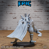 Rear angle of a frogfolk archer miniature showing a dramatically flowing stitched cloak, a strapped quiver of arrows, and a fan of bony head spines. Rope-wrapped staff visible at the side. Sculpt by Epic Miniatures.