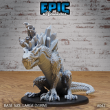 Crystal Drake Attack by Epic Miniatures — large drake rearing aggressively, jaws wide open, with jagged crystal shards erupting from neck and spine, dense overlapping scales across body, clawed forelegs braced forward, long curling tail, mounted on a large oval base.