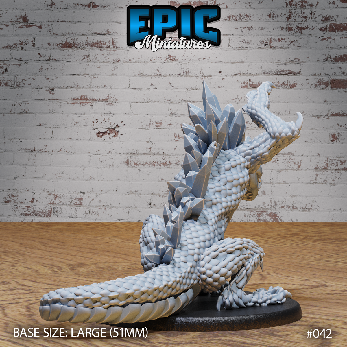 Crystal Drake Attack by Epic Miniatures — rear view showing the full ridge of angular crystal prisms running down the spine and back, tightly scaled body coiled low, head raised with open jaws, one clawed foot raised, long segmented tail trailing to the right on a large oval base.