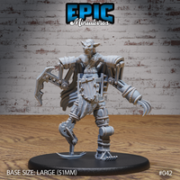 Snarling goblin operating a riveted mechanical suit with claw-tipped fingers, hooked blade arm, scythe-foot leg, rope-wrapped joints, and a billowing cape. Sculpt by Epic Miniatures.