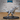 Armoured raptor miniature lunging forward with jaws wide open, spiked neck guard and shoulder plate armour, raised foreclaws, long balancing tail, on a large oval base. Sculpt by Epic Miniatures.