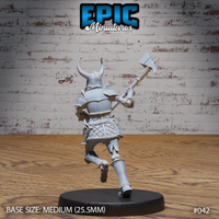 Armoured skeleton warrior seen from behind, striding forward with a spiked maul extended at arm's length. Full plate back armour, horned helm, quilted lower armour, and skeletal feet visible. Sculpt by Epic Miniatures.