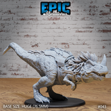 Ferocious horned theropod miniature in a forward-lunging pose, jaws wide open, with a riveted saddle and thick rope bridle wrapped around its snout and head. Sculpt by Epic Miniatures.