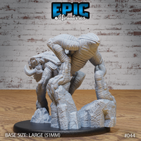 Cave Crawler by Epic Miniatures — view from behind showing the creature's towering spiked spine, long sinuous tail and powerful haunches braced over a rocky scatter base. Sculpt by Epic Miniatures.