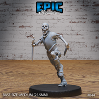 Skeleton warrior in a running lunge, both daggers drawn — one held low, one reversed — wearing tattered chainmail and partial plate armour, wide grinning skull. Sculpt by Epic Miniatures.