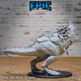 Saddled tyrannosaur miniature in a crouching, coiled stance viewed from the left, showing braided mane, rope chest harness, armoured saddle, and scaled hide detail. Sculpt by Epic Miniatures.