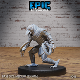Kenku rogue miniature leaning forward in a predatory crouch, gripping a large curved blade in one hand, wearing riveted leather armour, segmented vambraces, and scaled greaves, hooked beak angled downward. Sculpt by Epic Miniatures.