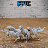 Five raptor miniatures grouped together, each with jaws open wide and sickle claws raised, scaled hides textured across lean muscular bodies. Sculpt by Epic Miniatures.