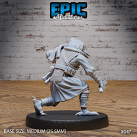Kenku miniature seen from behind showing heavy cloak folds, chainmail back, utility belt with pouch, and raised taloned foot mid-stride. Sculpt by Epic Miniatures.