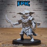 Goblin assassin miniature facing forward, dual curved blades raised, wearing scalemail armour and a layered neck wrap, fur-trimmed bracers and boots, snarling expression with bared fangs. Sculpt by Epic Miniatures.