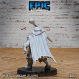 Dwarf summoner seen from behind, long flowing cape spreading wide, staff raised overhead, utility items visible on belt, dynamic striding pose with cape swept dramatically to one side. Sculpt by Epic Miniatures.