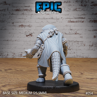 Rear of alligator folk miniature showing long coat, thick scaly tail, skulls strung on rope across the back, and rope coiled around both legs and arms. Sculpt by Epic Miniatures.