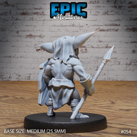 Goblin warrior seen from behind, wiry muscles visible across bare shoulders, a rough cloak draped to the hips, spear gripped low at his side, wrist and shin wrappings detailed. Sculpt by Epic Miniatures.