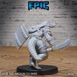 Alligator folk warrior seen from behind and to the side, shield arm extended outward showing full plank-and-rivet detail, serrated blade lowered at the hip, scaled tail visible. Leather strapping across torso. Sculpt by Epic Miniatures.