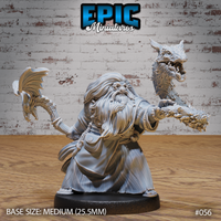 Stout bearded dwarf spellcaster holding two draconic bone staves aloft — one topped with a shaggy beast skull, one with a winged skeletal dragon head. Long robes, white beard, round spectacles. Sculpt by Epic Miniatures.
