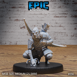 Crouching hobgoblin hunter gripping a small skull in one hand, pressing the other to the ground, with crossed blades and a feathered quiver across his back. Riveted pauldrons, fur-trimmed waist, bare clawed feet. Sculpt by Epic Miniatures.