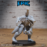 Alligator folk shaman in a wide predator's crouch, gripping a bone club, jaws open in a snarl, wearing rope bindings and feather fetishes over dense crocodilian scales. Sculpt by Epic Miniatures.
